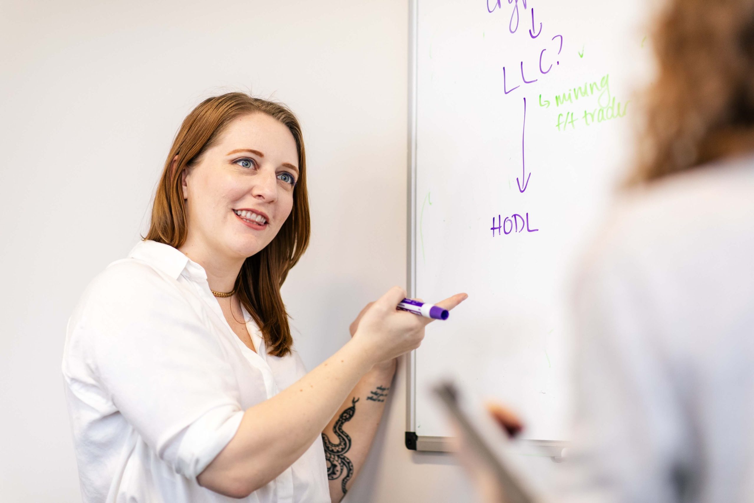 Employees at Gordon Law brainstorming on a whiteboard.
